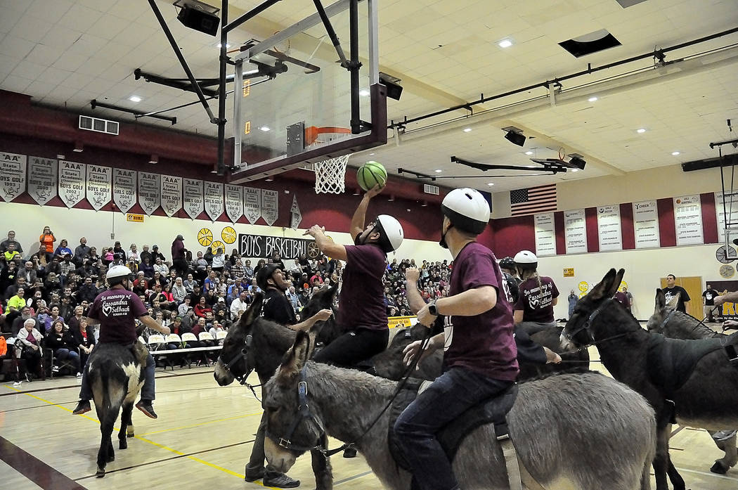 Horace Langford Jr./Pahrump Valley Times A packed house watches as the Pahrump Valley High School faculty/staff team goes in for a score during Friday night's Donkey Basketball game at the high sc ...