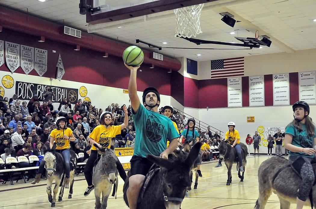 Horace Langford Jr./Pahrump Valley Times A fast break is never a guarantee of a basket in Donkey Basketball, an annual fundraising game sponsored by the faculty and staff at Pahrump Valley High Sc ...