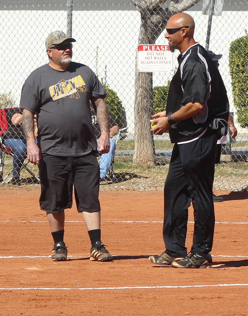 Tom Rysinski/Pahrump Valley Times Umpires Dom Sandoval and Shawn Mendoza plot how to maintain order between innings of the Batting 1.000 Challenge on Sunday at Petrack Park.