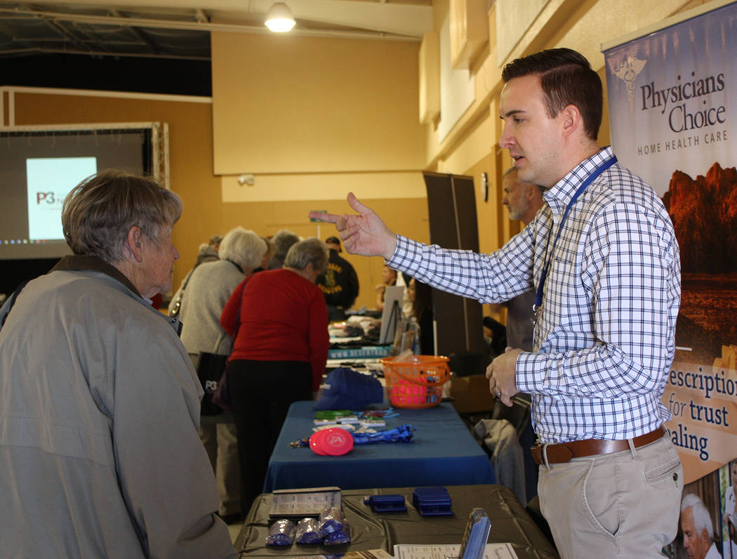 Robin Hebrock/Pahrump Valley Times A representative with Physicians Choice Home Health Care speaks with an attendee at the P3 Medical Group Health Information Fair, hosted in February.