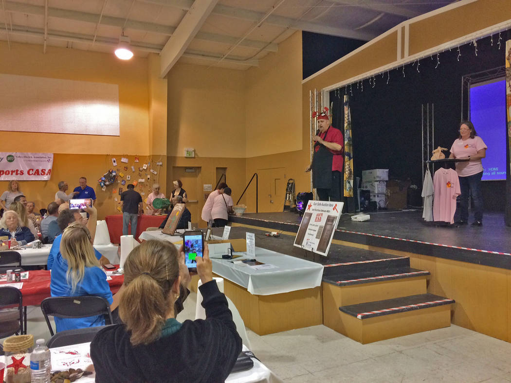 Robin Hebrock/Pahrump Valley Times CASA Executive Director Kathie McKenna, far right, and Crab Fest founder Brian Kunzi, shown wearing his well-known crab hat, addressed the crowd at the 2019 even ...