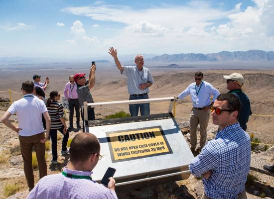 Wiilliam Boyle of the Department of Energy's Office of Nuclear Energy, center, speaks at the crest of Yucca Mountain during a congressional tour near Mercury on Saturday, July 14, 2018. Chase Stev ...