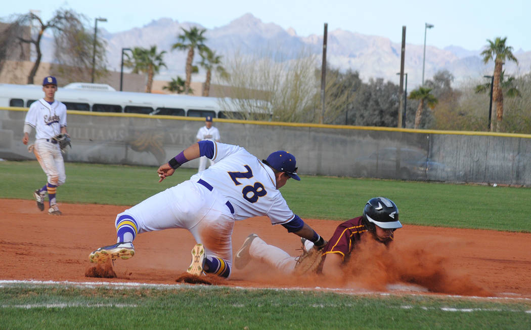 Charlotte Uyeno/Pahrump Valley Times Pahrump Valley's Jalen Denton dives safely back to first base during the Trojans' 5-1 loss to Southwest, California, in the Route 66 Tournament on Saturday in ...