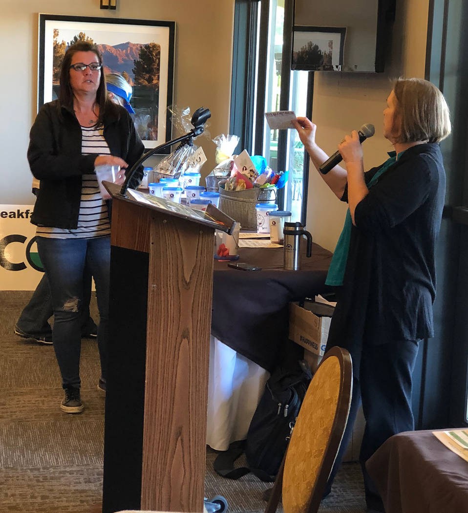 Tom Rysinski/Pahrump Valley Times Kim Taylor, left, and Salli Kerr draw and announce winning raffle tickets Saturday after the No To Abuse Golf Tournament at Mountain Falls Golf Club in Pahrump.