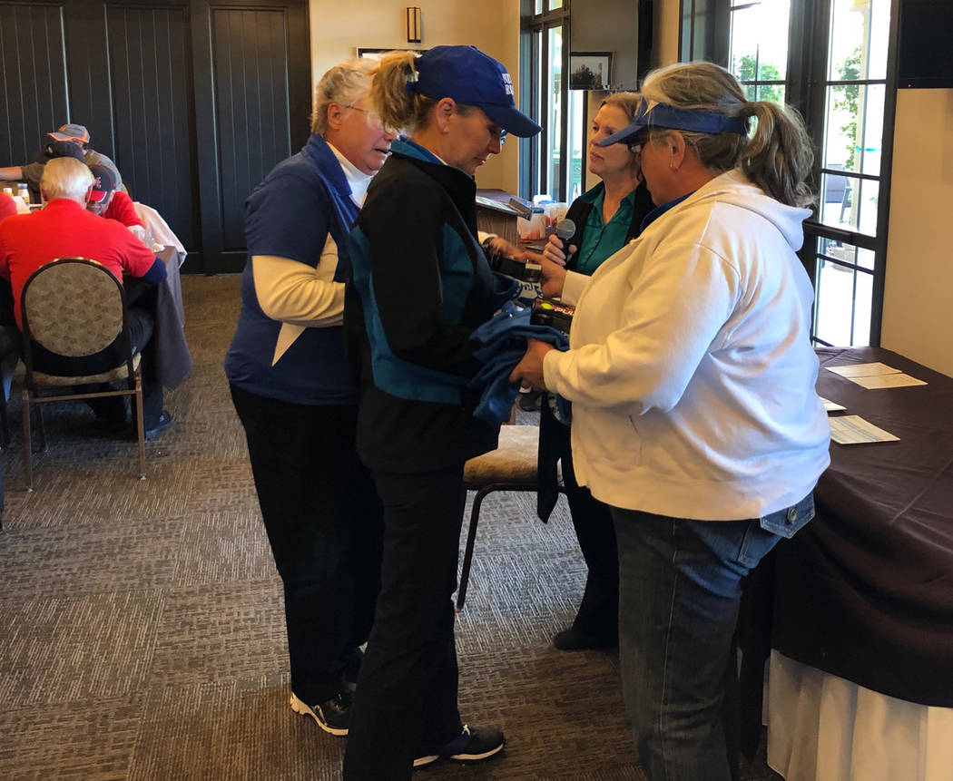 Tom Rysinski/Pahrump Valley Times Salli Kerr, second from right, gives members of the Nevada Realty women's foursome their prizes for finishing last at the No To Abuse Golf Tournament on Saturday ...