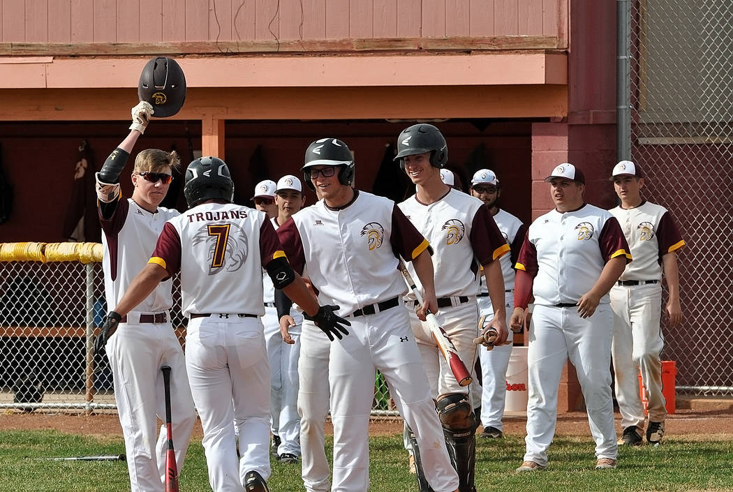 Horace Langford Jr./Pahrump Valley Times Sophomore Jalen Denton is greeted by teammates at home plate after leading off the game with a home run Monday against Boulder City in Pahrump.