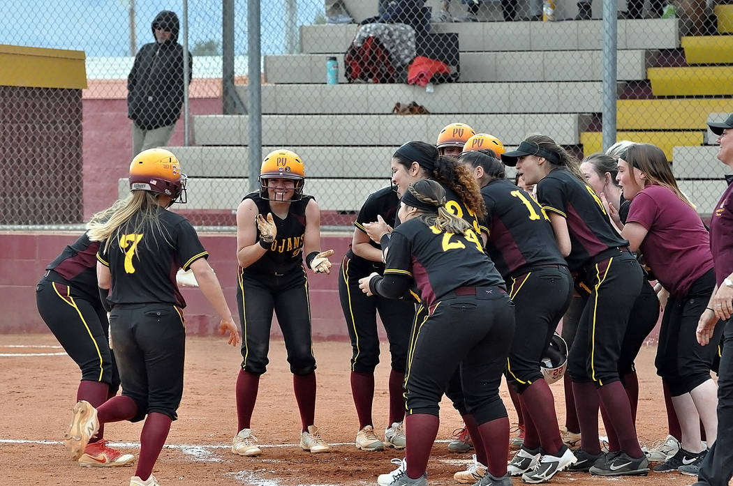 Horace Langford Jr./Pahrump Valley Times The Pahrump Valley softball team waits to greet sophomore Ally Rily at home plate after her 3-run home run in the fifth inning gave the Trojans an 11-9 lea ...