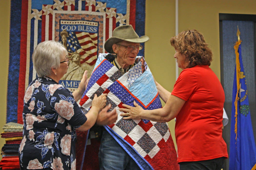 Robin Hebrock/Pahrump Valley Times Ladies of the Nye County Valor Quilters drape a Quilt of Valor around Army veteran Paul Riley.