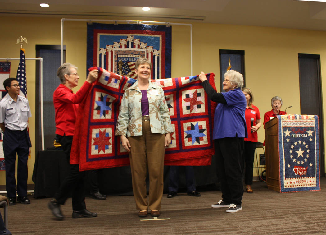 Robin Hebrock/Pahrump Valley Times U.S. Marine Corps veteran Laurie Wilson beams happily as she stands before her brand new Quilt of Valor.