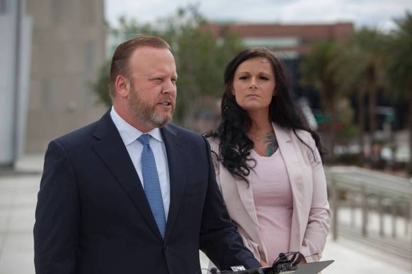 Attorney Jay Ellwanger addresses media alongside his client Jennifer Glover outside the federal court house in Las Vegas, Monday, March 11, 2019. Glover is a former Nevada National Security Site e ...
