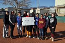 Horace Langford Jr./Pahrump Valley Times Pahrump Youth Softball Association players pose with an oversized check representing $2,755, the proceeds from their Batting 1.000 Classic game earlier thi ...