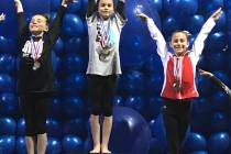 Melissa Plant/Special to the Pahrump Valley Times Arianna Plant, center, on the medal stand after her 9.775 score on the balance beam won her gold at the Nevada State Gymnastics Championships.