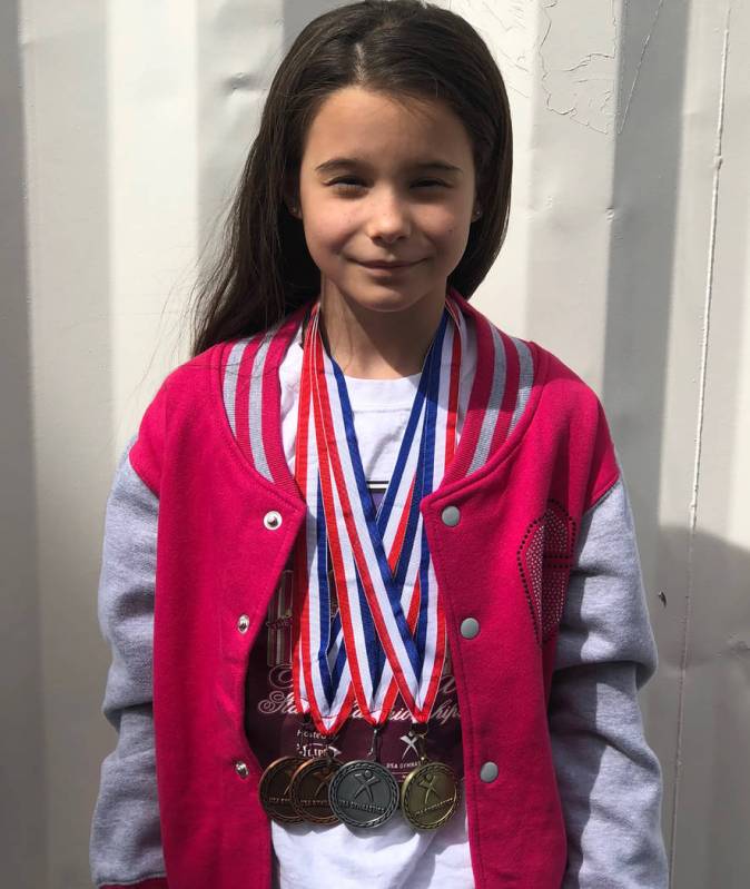Tom Rysinski/Pahrump Valley Times Arianna Plant, 10, displays the medals she won, including gold in the balance beam, at the Nevada State Gymnastics Championships on March 15-17 in Reno.