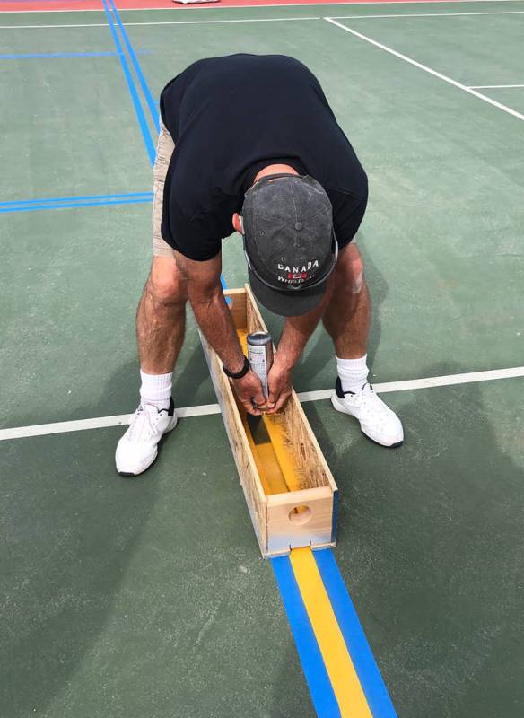 Tom Rysinski/Pahrump Valley Times Jim Groebner applies paint to a Petrack Park tennis court on ...