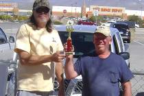Mike Norton/Special to the Pahrump Valley Times Latham Dilger, left, presents Dave Barefield with the trophy for winning a chili cook-off held during the horseshoes and cornhole tournaments Saturd ...