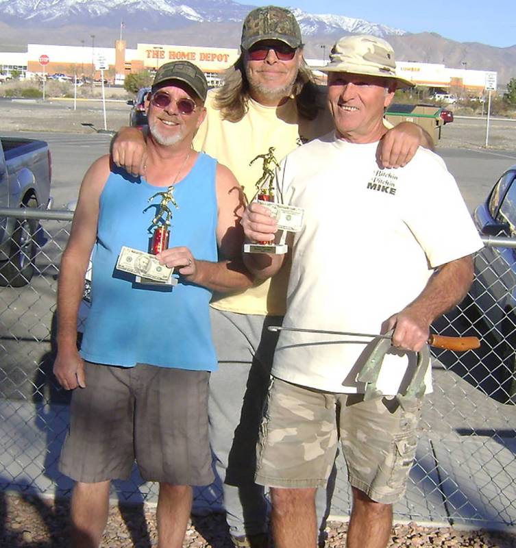 Mike Norton/Special to the Pahrump Valley Times Latham Dilger, center, presents Mark Kaczmarek, left, and Mike Nicosia with trophies and payouts after they won the horseshoes tournament run in con ...