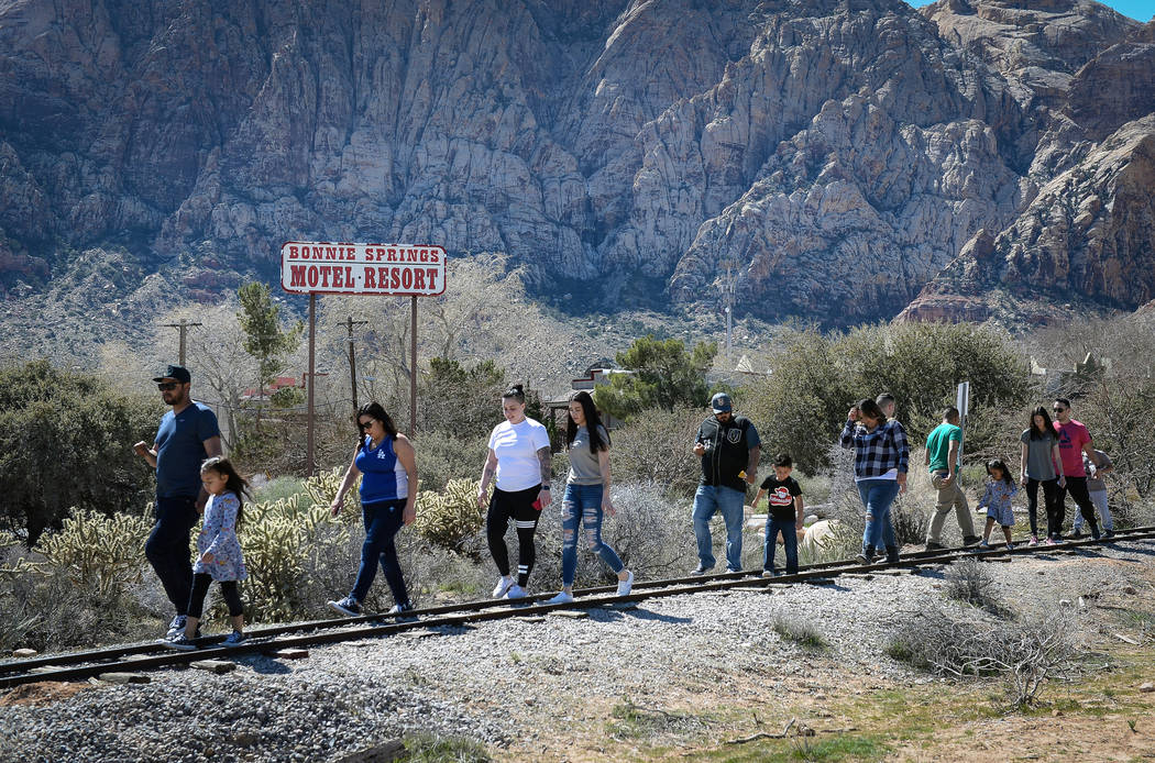 People walk along a train track during the last day of operations at Bonnie Springs Ranch in Las Vegas, Sunday, March 17, 2019. (Caroline Brehman/Las Vegas Review-Journal) @carolinebrehman
