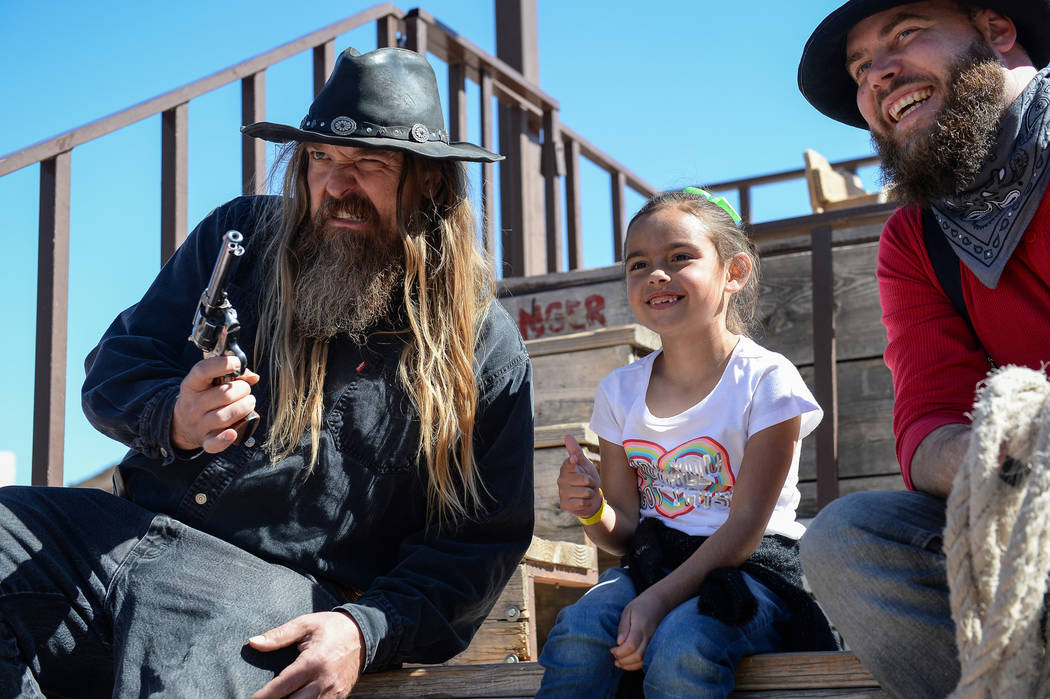 Ellie Mendoza, 7, from Las Vegas, middle, poses for a photograph with Jesse Reeder, left, and Mike Kelly during the last day of operations at Bonnie Springs Ranch in Las Vegas, Sunday, March 17, 2 ...