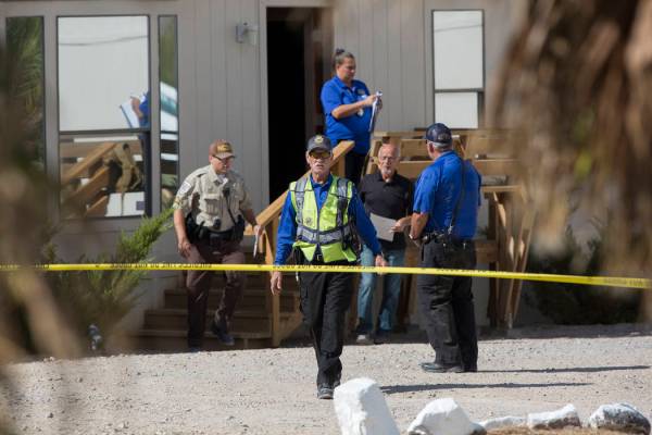 Benjamin Hager Las Vegas Review-Journal Nye County law enforcement investigate the scene at Den ...
