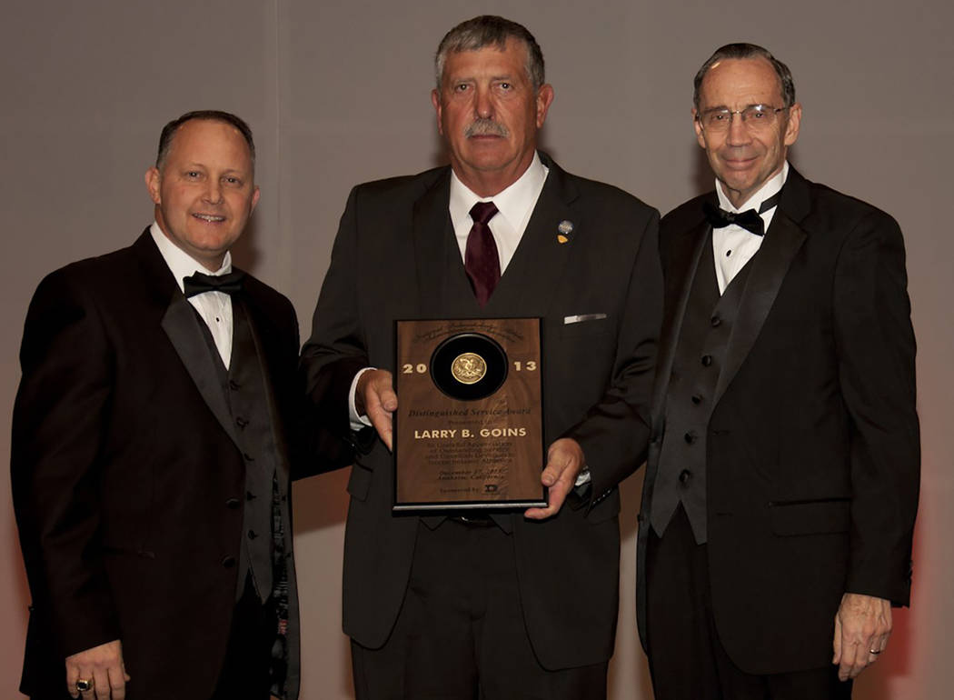 Special to the Pahrump Valley Times Larry Goins, center, receives a distinguished service award ...