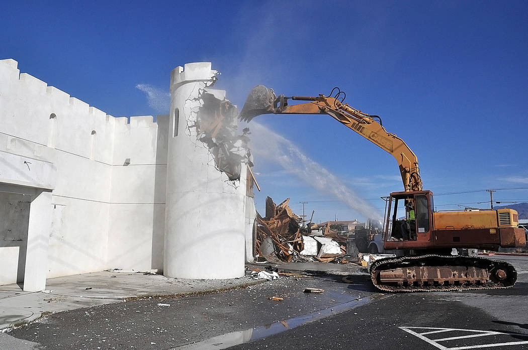 Horace Langford Jr./Pahrump Valley Times The bucket of an excavator takes down a raised sectio ...