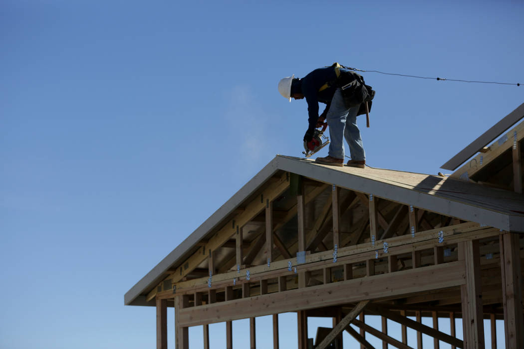 Michael Quine/Las Vegas Review-Journal.com Construction worker finishes up the rooftop on a ne ...