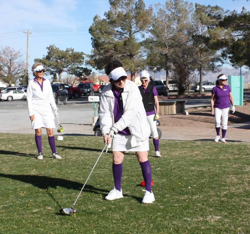 Robin Hebrock/Pahrump Valley Times Marcia Walling prepares to take her first swing in the chari ...