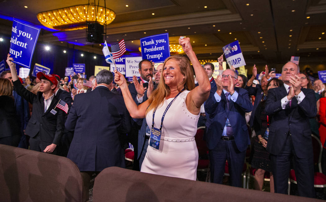 (L.E. Baskow/Las Vegas Review-Journal) @Left_Eye_Images Attendees cheer and applaud as Presiden ...