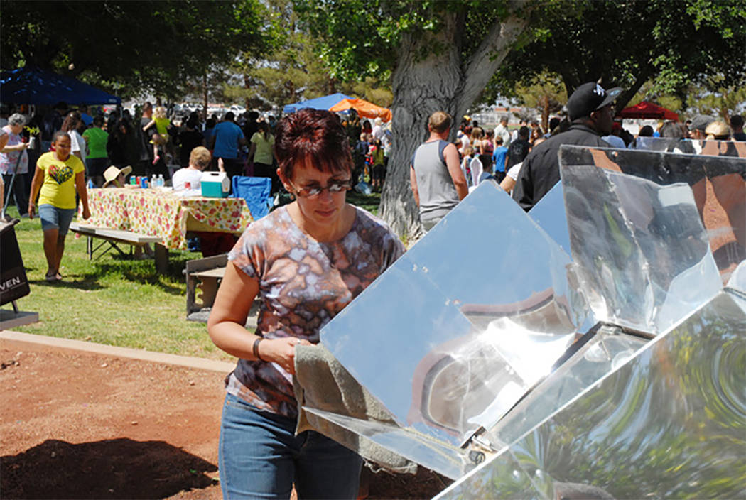 Patti Scharf is shown giving a baking demonstration with solar ovens during a previous Earth Da ...
