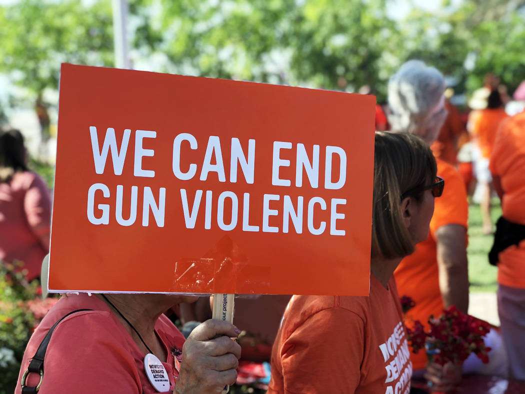 A sign promoting an end to gun violence is held up at the Wear Orange campaign event at the Las ...