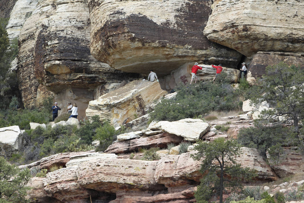 Archaeologists and volunteers work Thursday, May 19, 2011, to restore an ancient rock art site ...