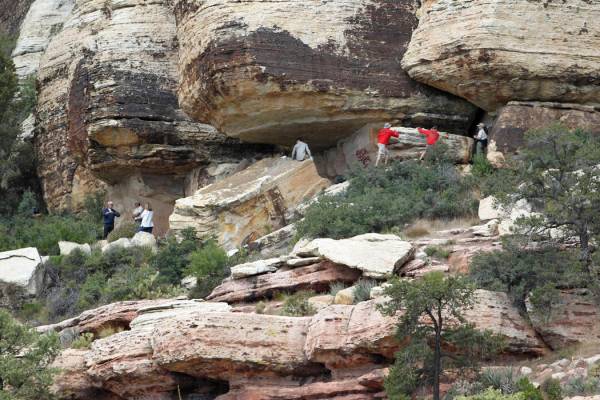 Archaeologists and volunteers work Thursday, May 19, 2011, to restore an ancient rock art site ...