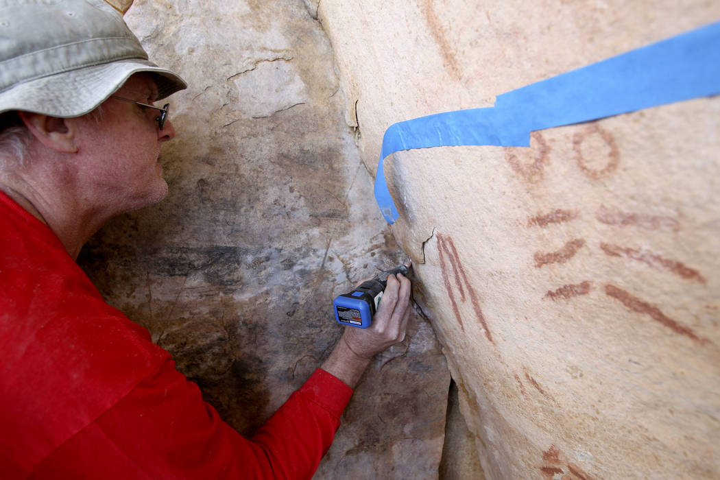Wyatt Mulvey, a volunteer with Friends of Red Rock Canyon, works Thursday, May 19, 2011, to res ...