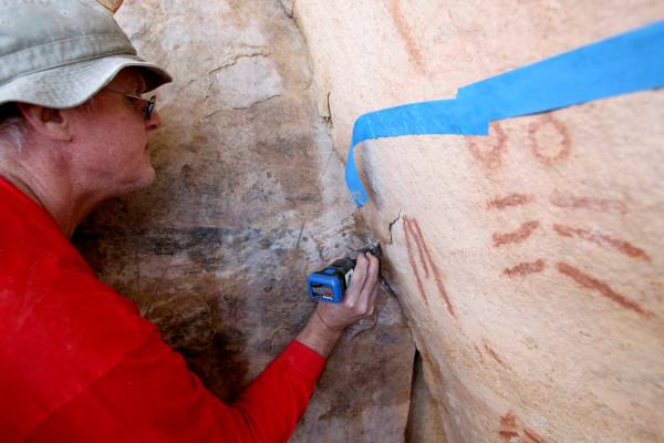 Wyatt Mulvey, a volunteer with Friends of Red Rock Canyon, works Thursday, May 19, 2011, to res ...