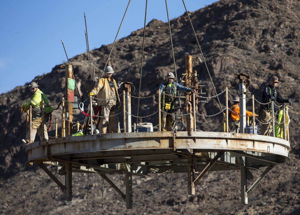 Richard Brian/Las Vegas Review-Journal Workers prepare to be lowered down the access shaft for ...