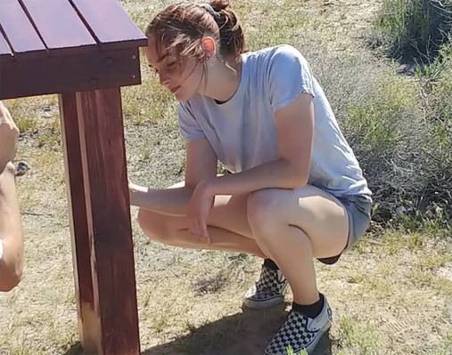Special to the Pahrump Valley Times Taylor Williamson applies a waterproof stain to one of seve ...