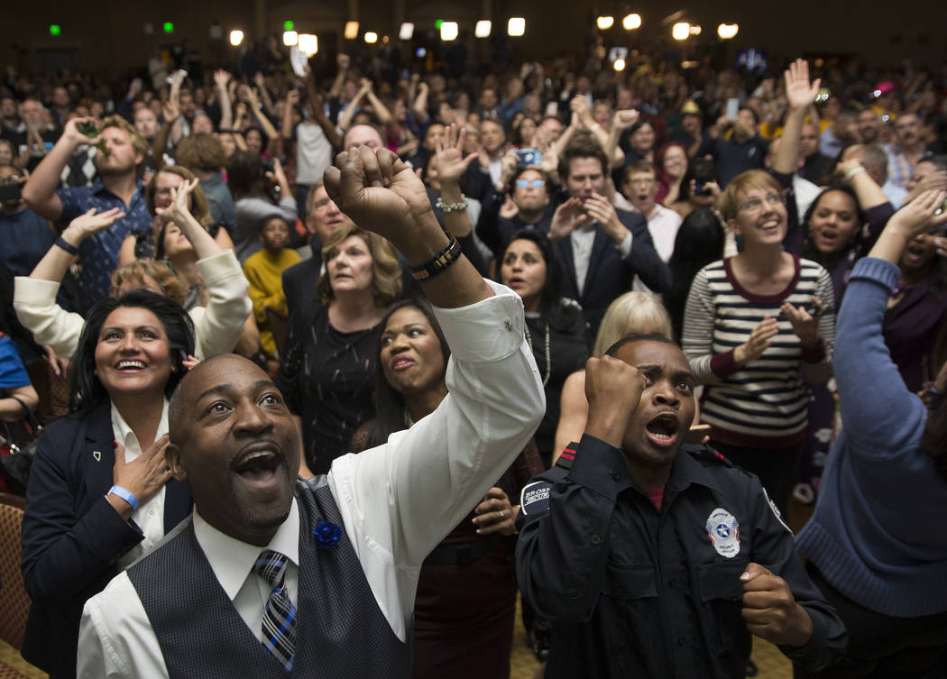 Assemblyman Tyrone Thompson, left, cheers as results come in for Congresswoman Jacky Rosen duri ...