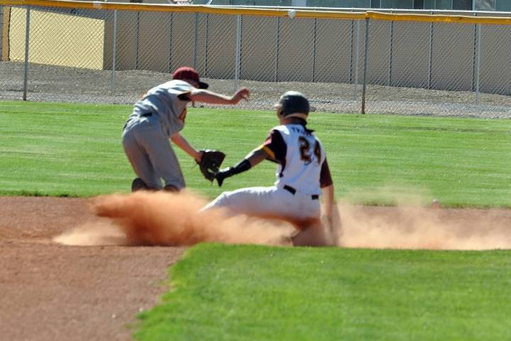 Horace Langford Jr./Pahrump Valley Times Senior Willie Lucas reaches second base in a cloud of ...