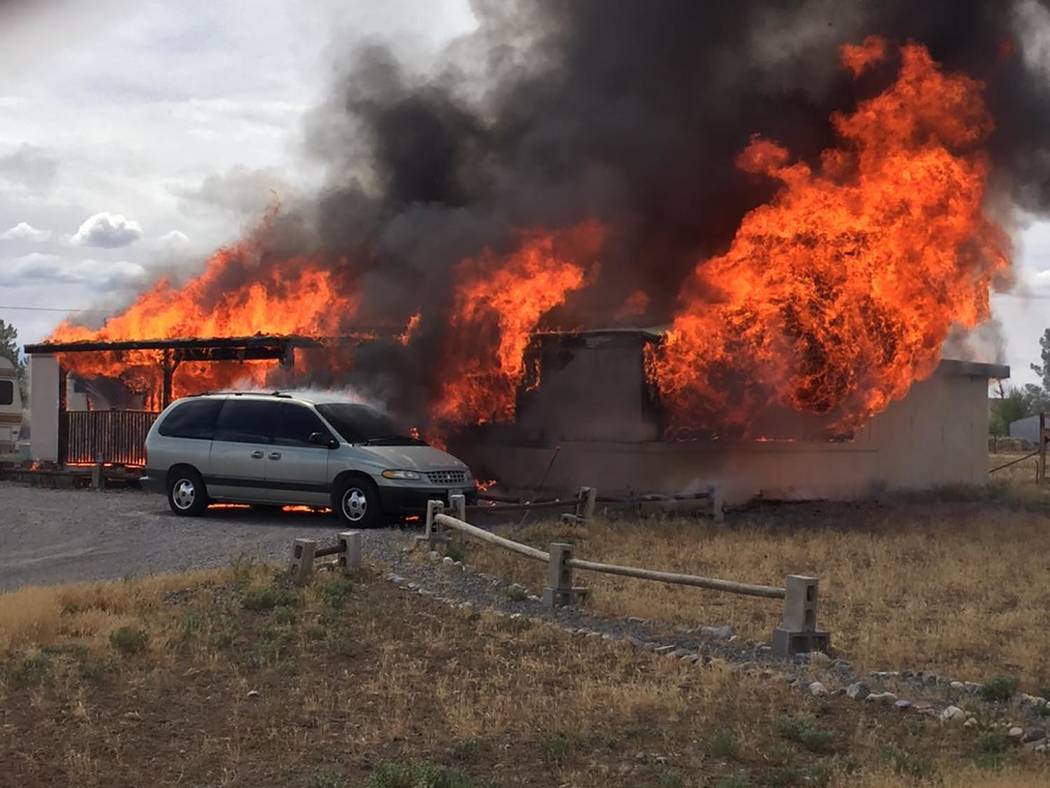 Special to the Pahrump Valley Times A late morning fire destroyed a double-wide manufactured ho ...