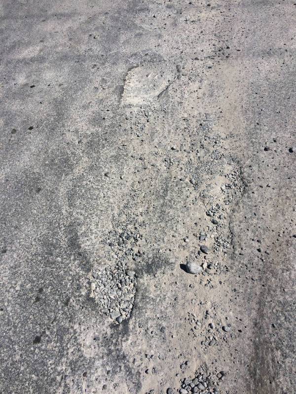 Robin Hebrock/Pahrump Valley Times These potholes at the intersection of Turner Boulevard and Q ...