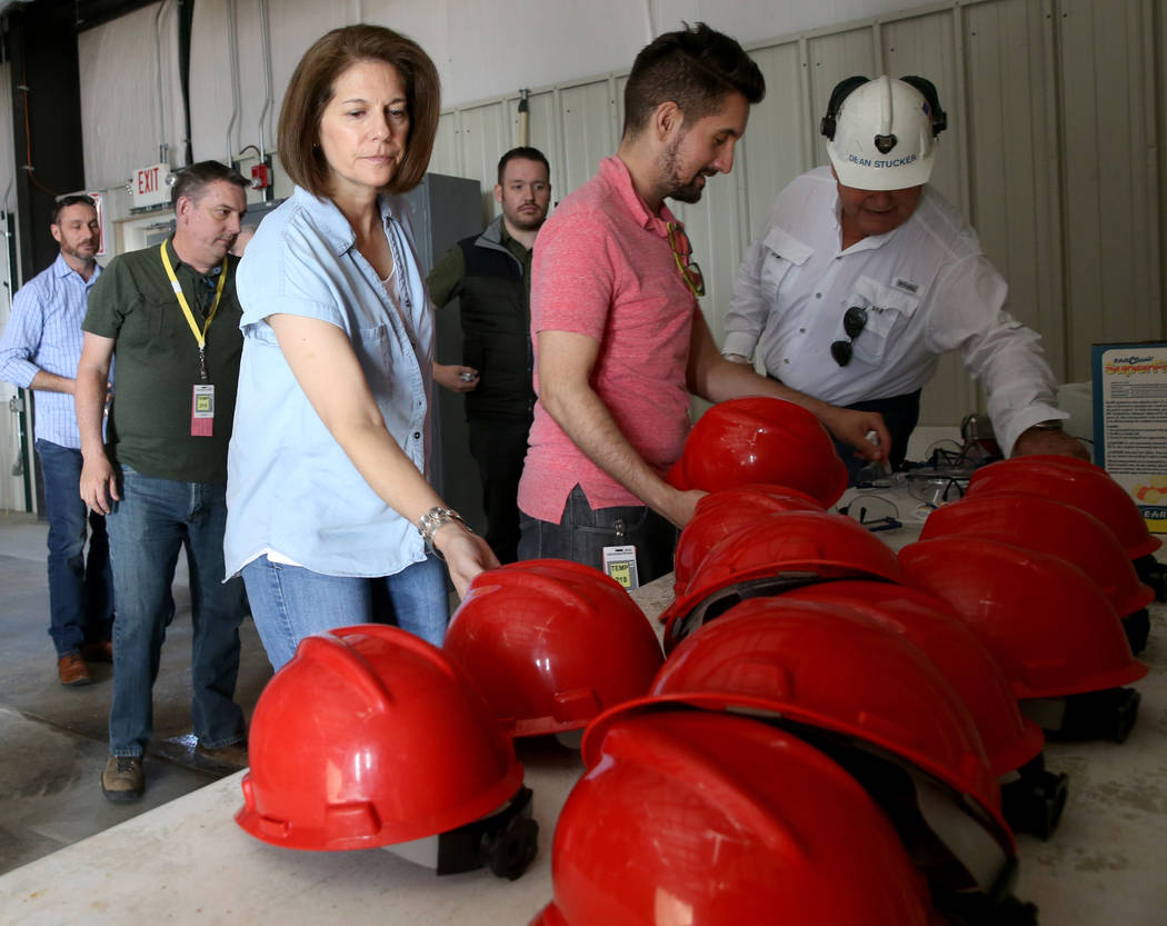 U.S. Sen. Catherine Cortez Masto, D-Nev., takes a hard hat before a tour of Yucca Mountain 90 m ...