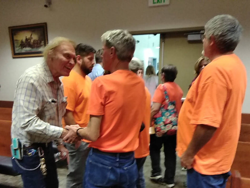 Selwyn Harris/Pahrump Valley Times Christina Weir's father Jim, (center), and clad in an orange ...