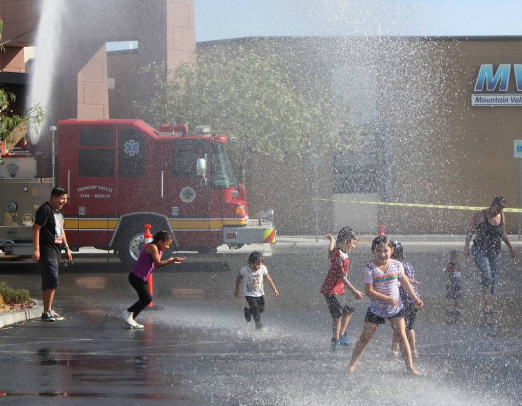 Robin Hebrock/Pahrump Valley Times Dancing in the shower of spray from the Pahrump Valley Fire ...