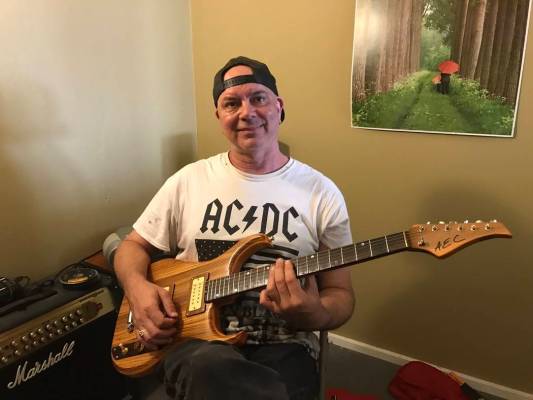Jeffrey Meehan/Pahrump Valley Times Gary Fox, owner of Foxter Music in Pahrump, sits with his g ...