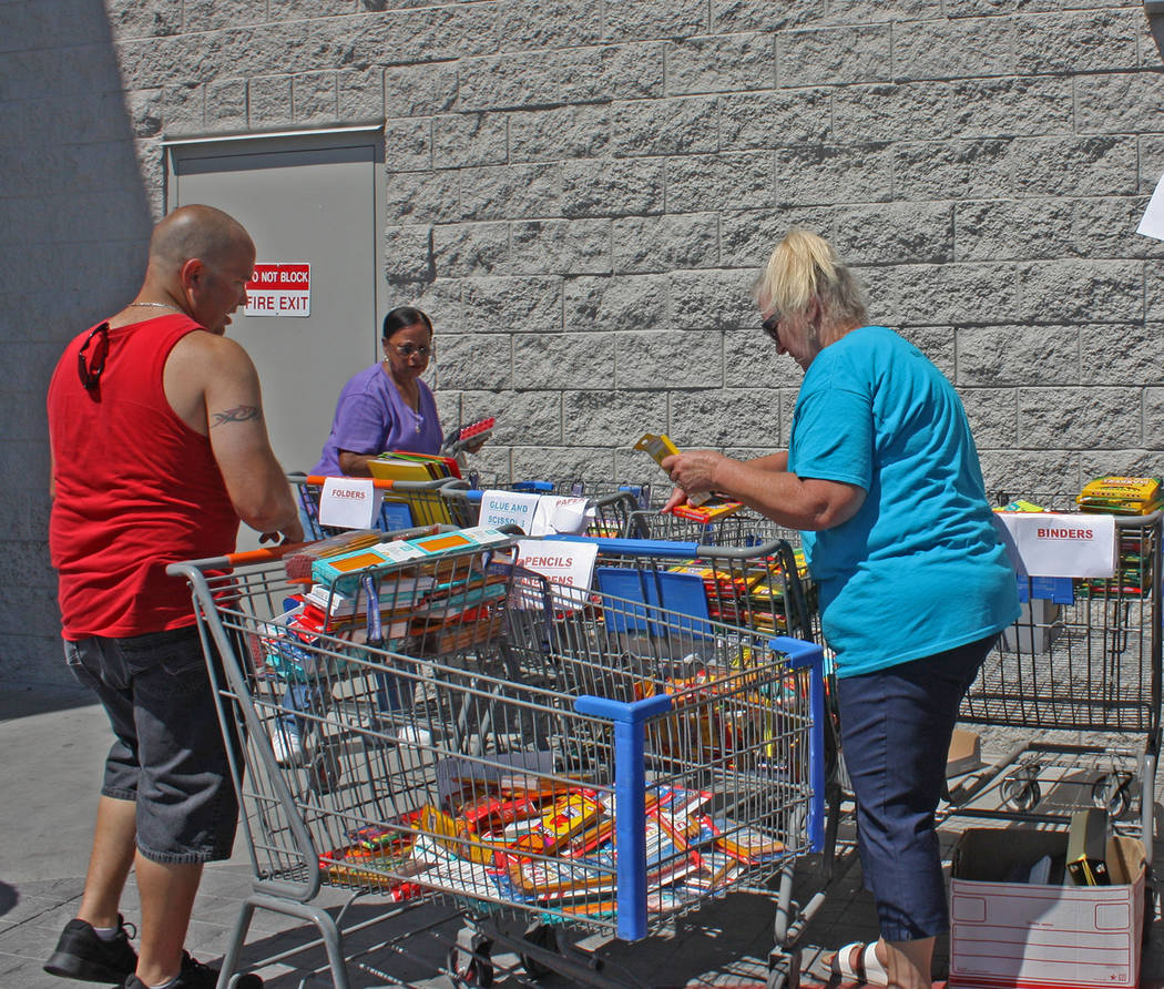 Robin Hebrock/Pahrump Valley Times Volunteers are shown sorting the many donations of school su ...