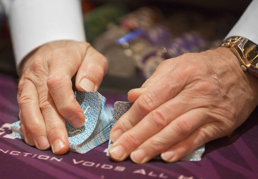 A dealer shuffles cards at the blackjack table at SLS Las Vegas on Thursday, May, 30, 2019, in ...