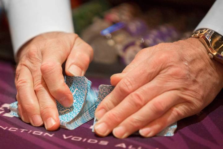 A dealer shuffles cards at the blackjack table at SLS Las Vegas on Thursday, May, 30, 2019, in ...