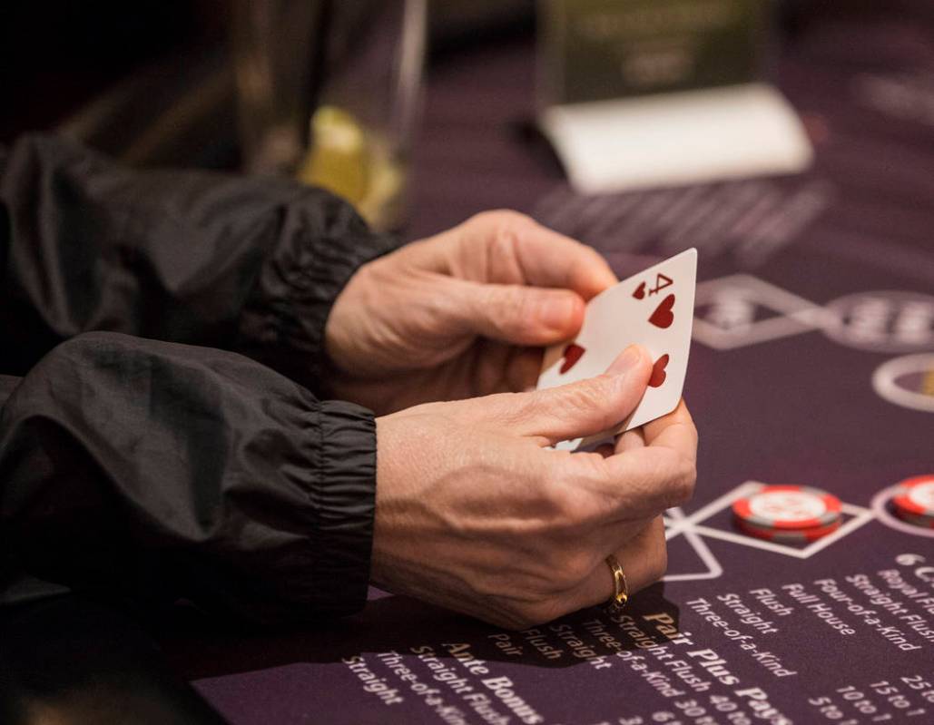 A gambler looks at her cards at a blackjack table at SLS Las Vegas on Thursday, May, 30, 2019, ...