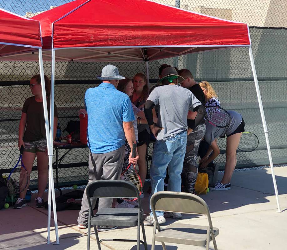 Tom Rysinski/Pahrump Valley Times Tennis players and coaches take a water break in the shade du ...