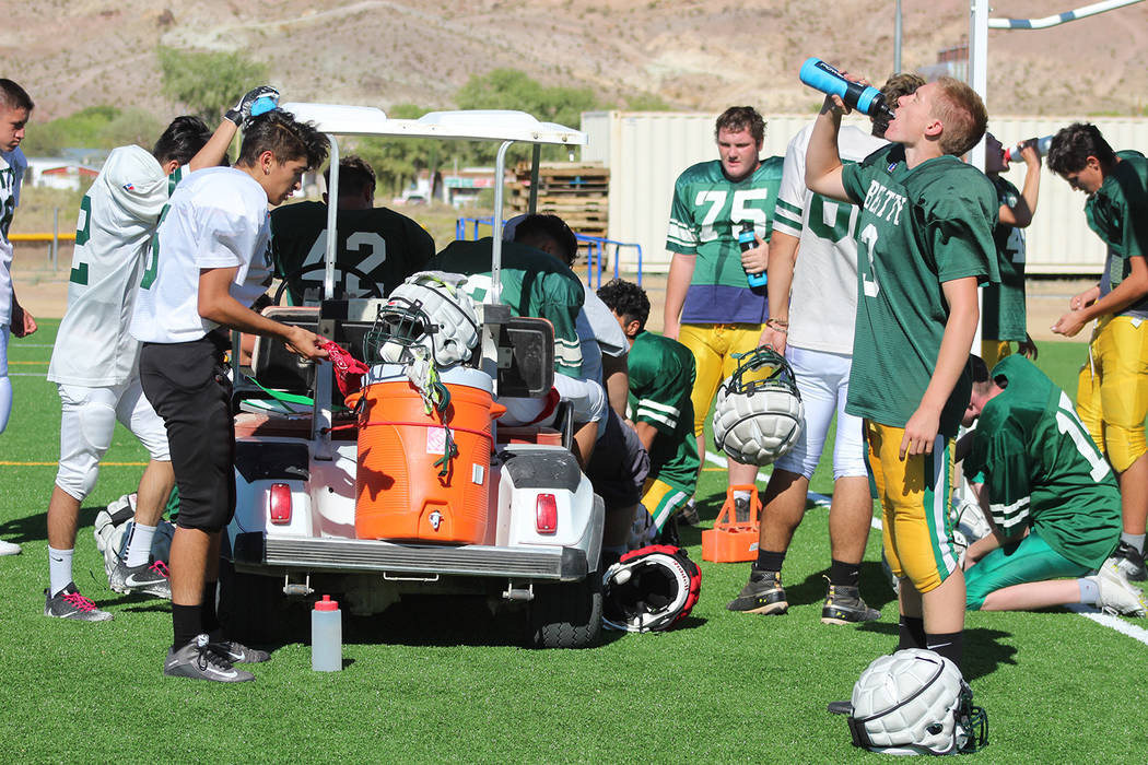 Tom Rysinski/Pahrump Valley Times Beatty High School football players take a water break during ...